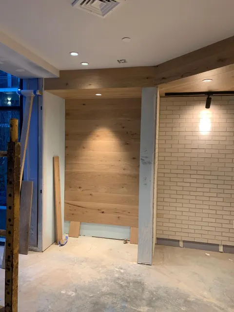 Wood paneling and brick wall in progress